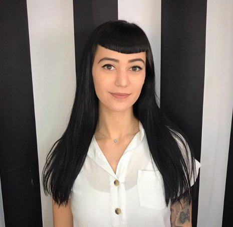 Long glossy black hair with short blunt bangs